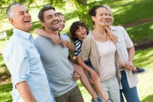 Cheerful extended family standing at park