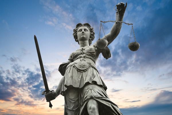 Lady Justice sometimes forces us into treatment against our own wills, but this is often the jolt we need to wake us up. (ER_09/Shutterstock)