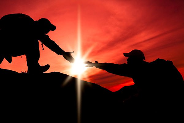 We can help others reach the highest heights, if we only take the time to reach out every once in a while. (Tom Wang/Shutterstock)
