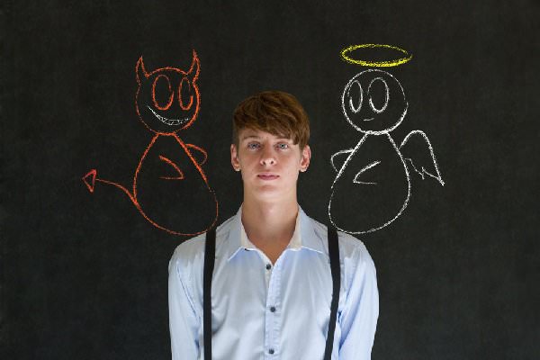 Everyone has a little angel and devil on their shoulder, pulling them in opposite directions. Which will you choose? (Photo Africa/Shutterstock)