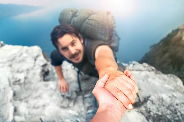 In order to take Step Five, we must trust another person to help us reach new heights in our recovery. (frankie’s/Shutterstock)