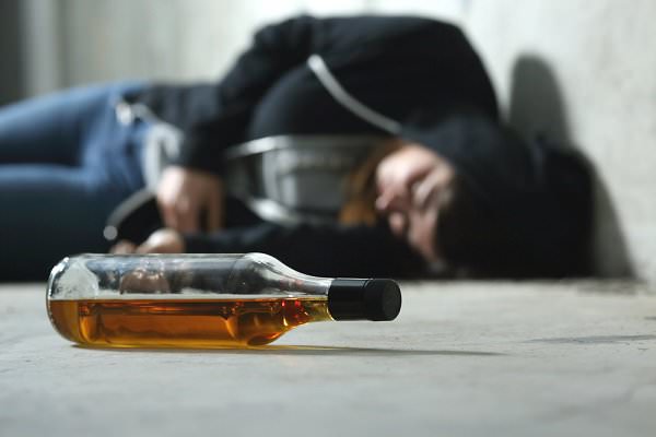 We’ve seen similar pictures where the bottle was replaced by a needle. So how do drugs and alcohol compare? (Antonio Guillem/Shutterstock)