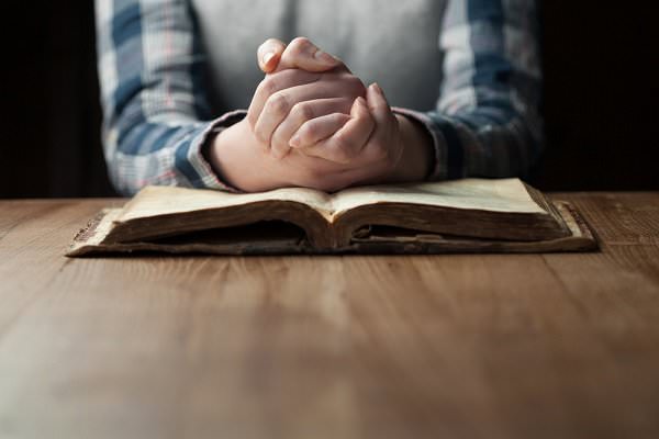 There are many books with daily prayers and meditations, although we may also wish to simply speak from the heart. (4Max/Shutterstock)