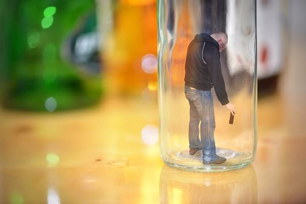 Your loved one may feel truly trapped by their drinking or drug abuse. (esfera/Shutterstock)